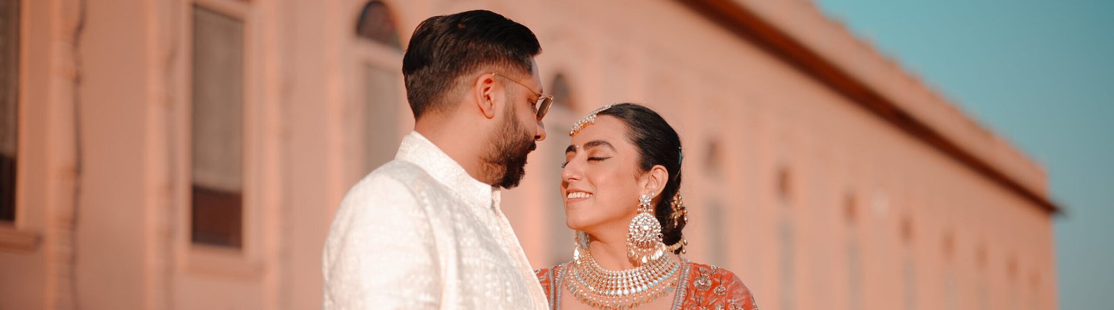 Sahiba & Vaibhav’s Heritage Wedding in Rajasthan 1 Couple posing before a heritage hotel