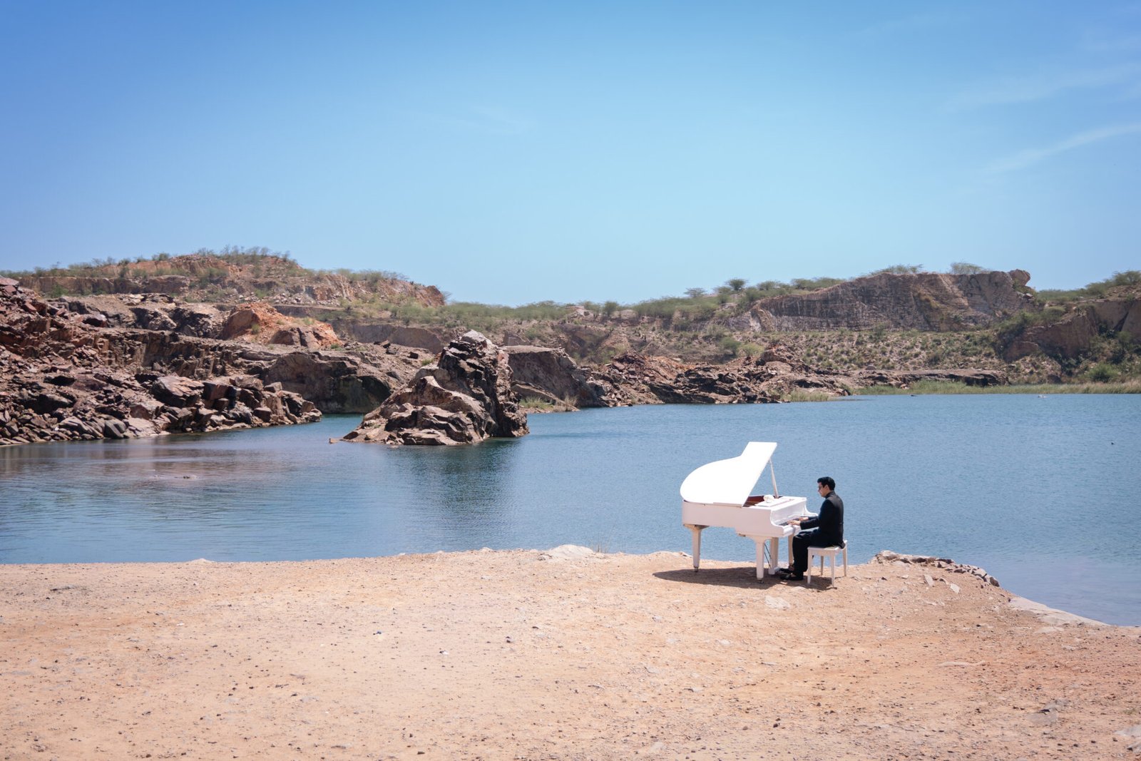 Dr Aman Bathla performing near a lake on his piano